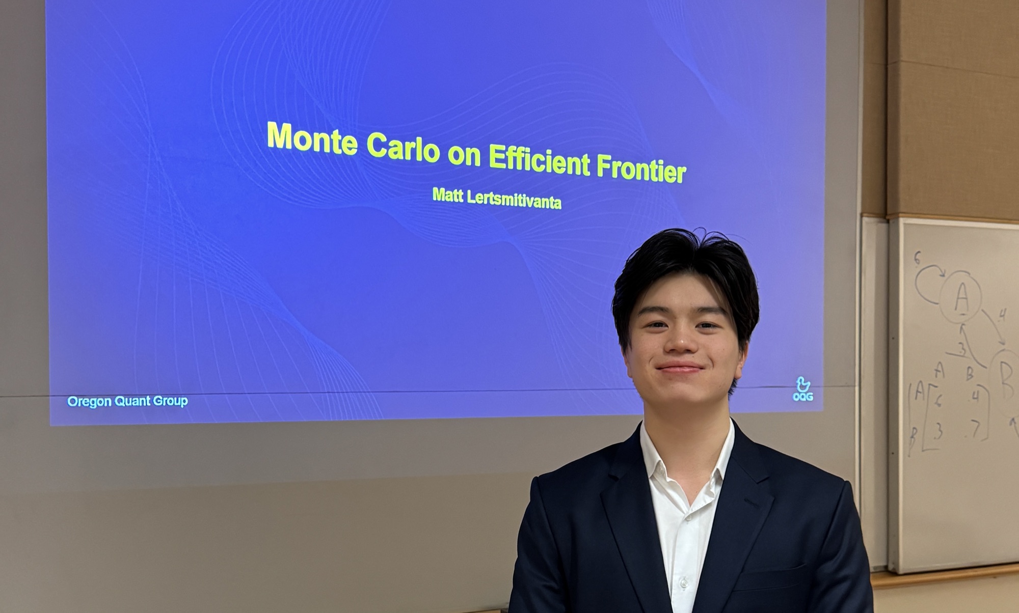 A member presenting a Monte Carlo efficient frontier study beside a whiteboard