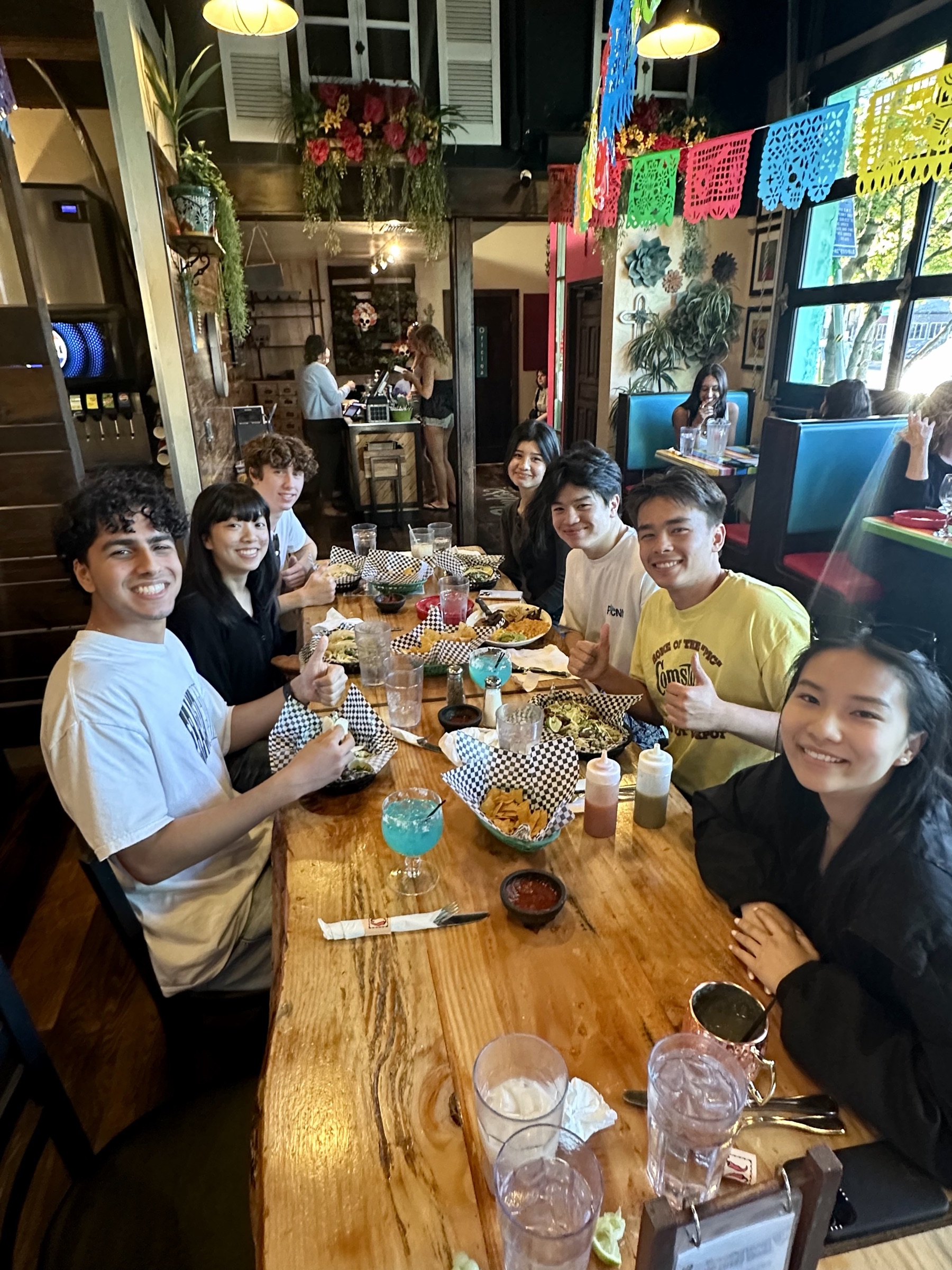 Members sharing dinner around a long restaurant table
