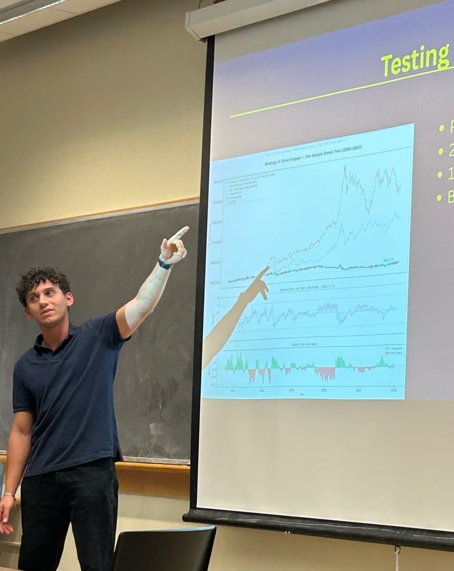 An OQG analyst pointing to a backtest chart during a strategy presentation